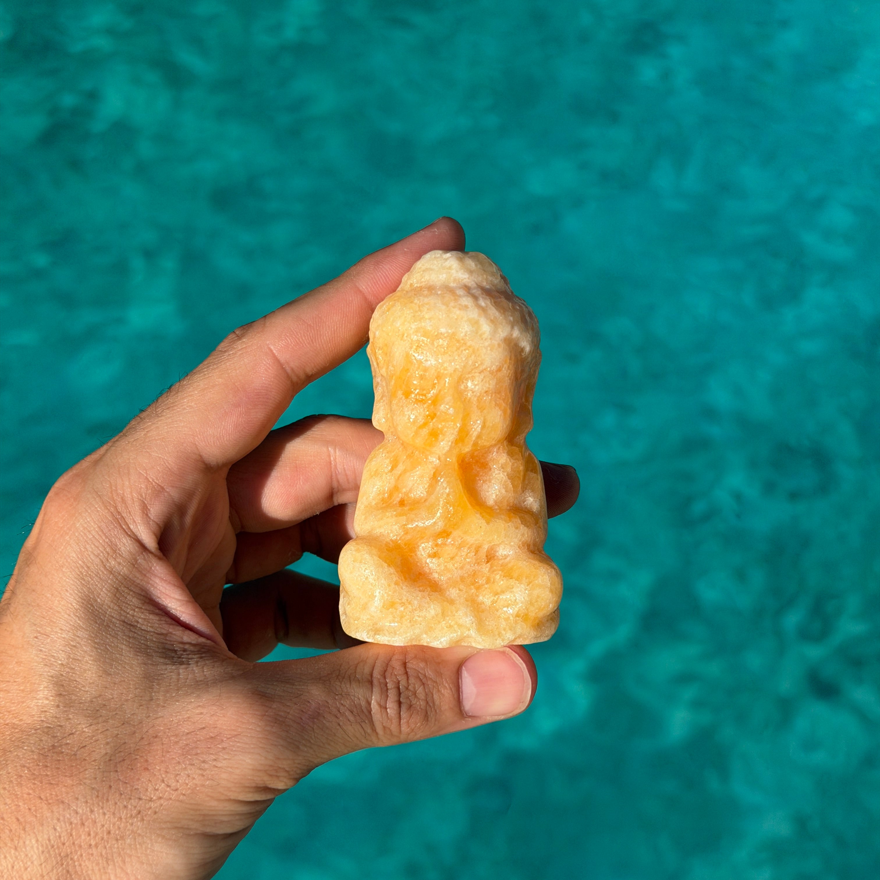 Orange Calcite Buddha Carving